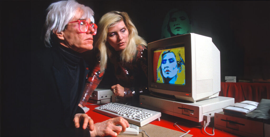 Andy Warhol creating art on the original Macintosh Computer